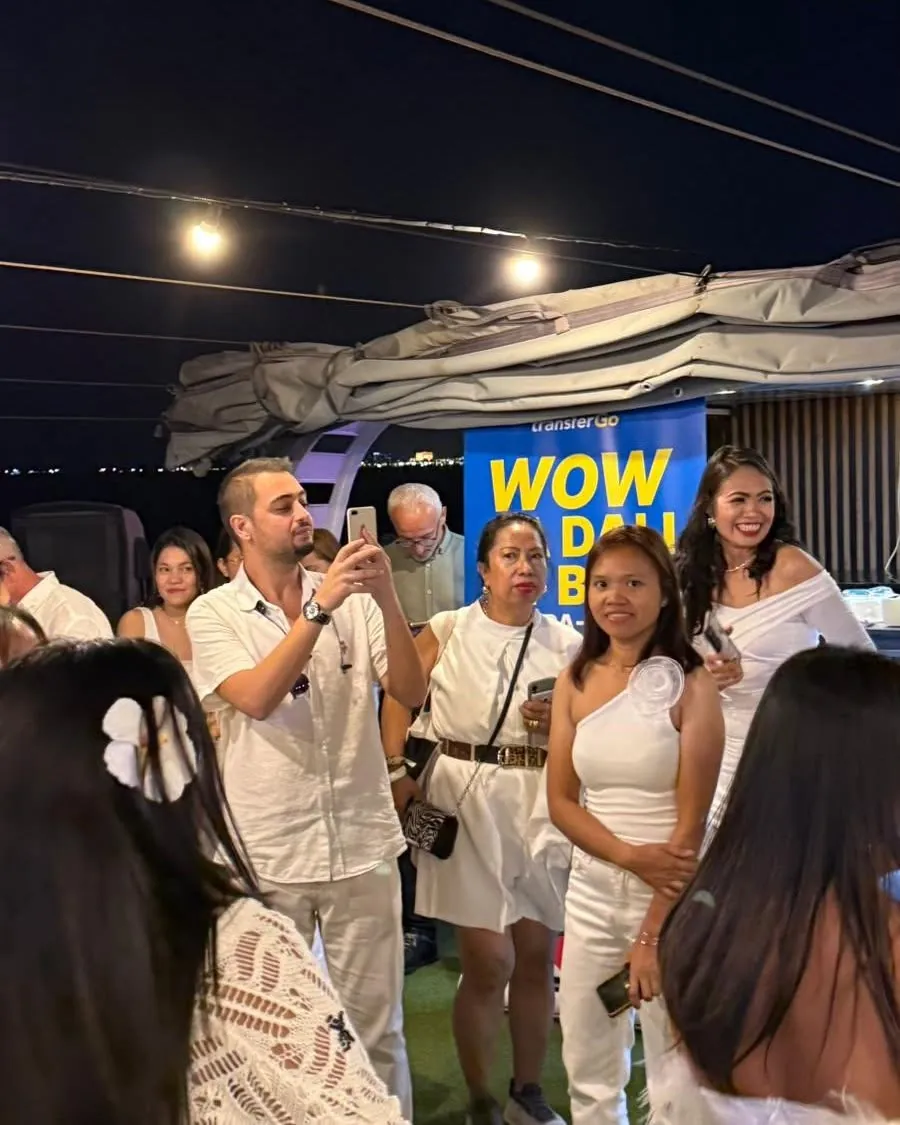 Evening community gathering with the TransferGo banner