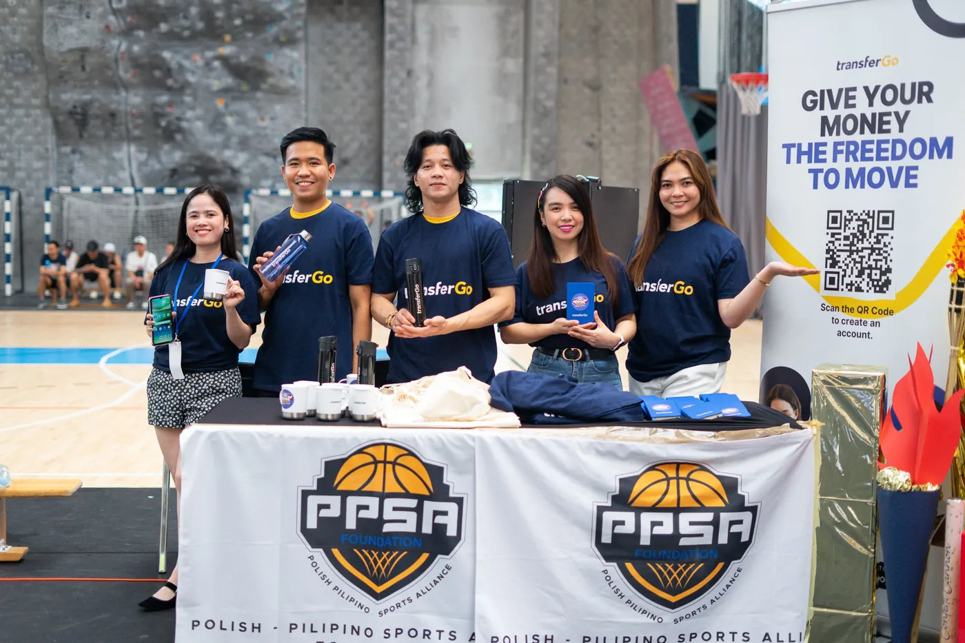 TransferGo team at the OWWA Cup basketball tournament booth