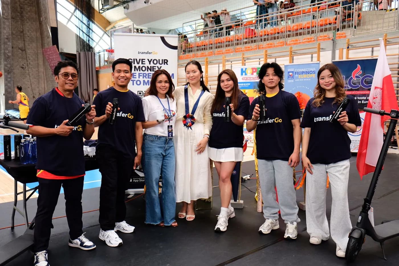 Community members with TransferGo tote bags at the OWWA Cup