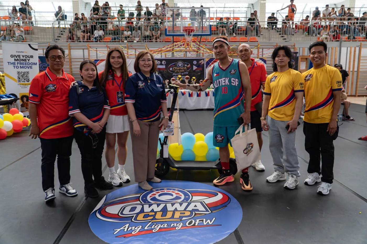 Group photo with the TransferGo banner at the OWWA Cup