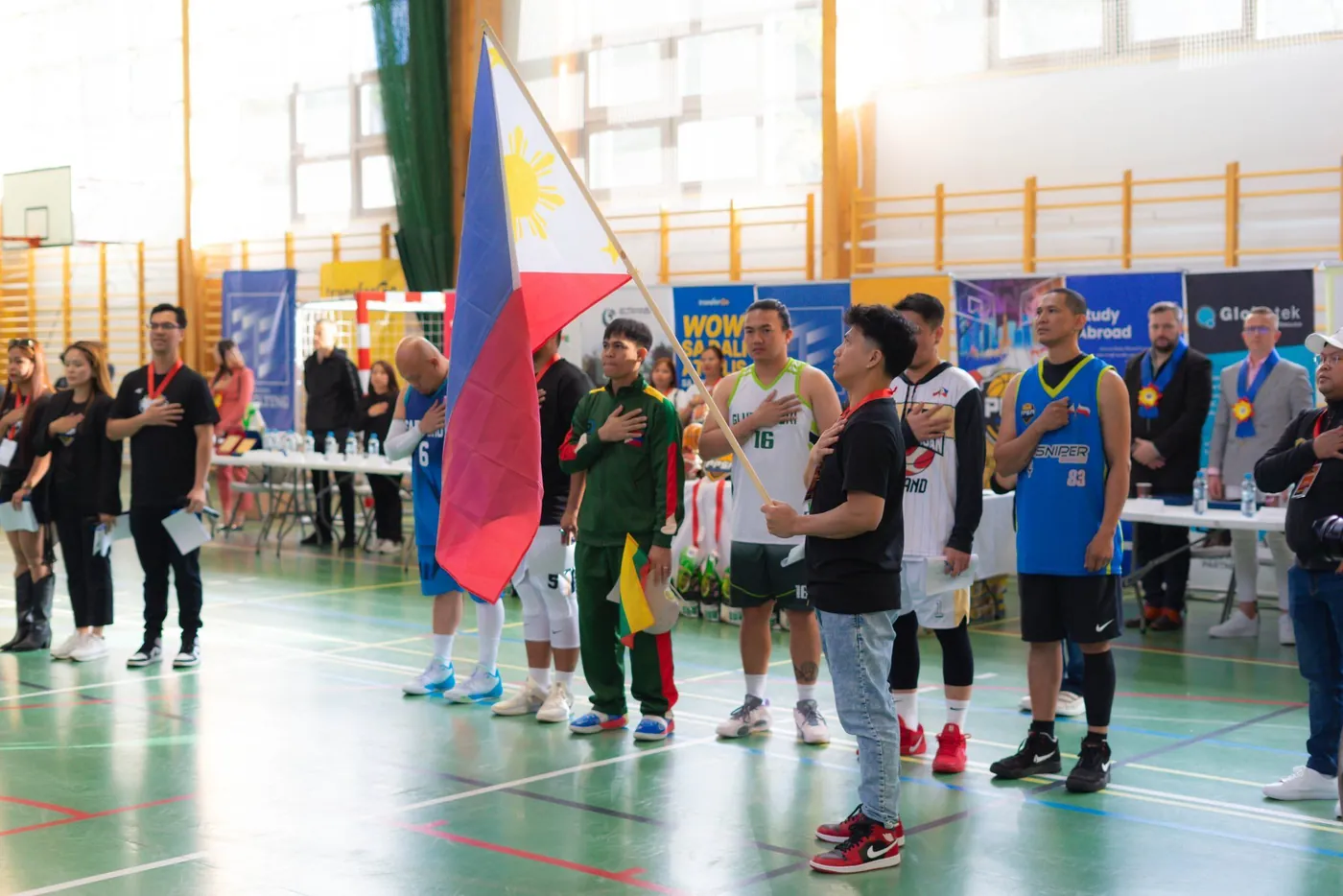 Filipino community sports tournament in Poland with TransferGo banners courtside