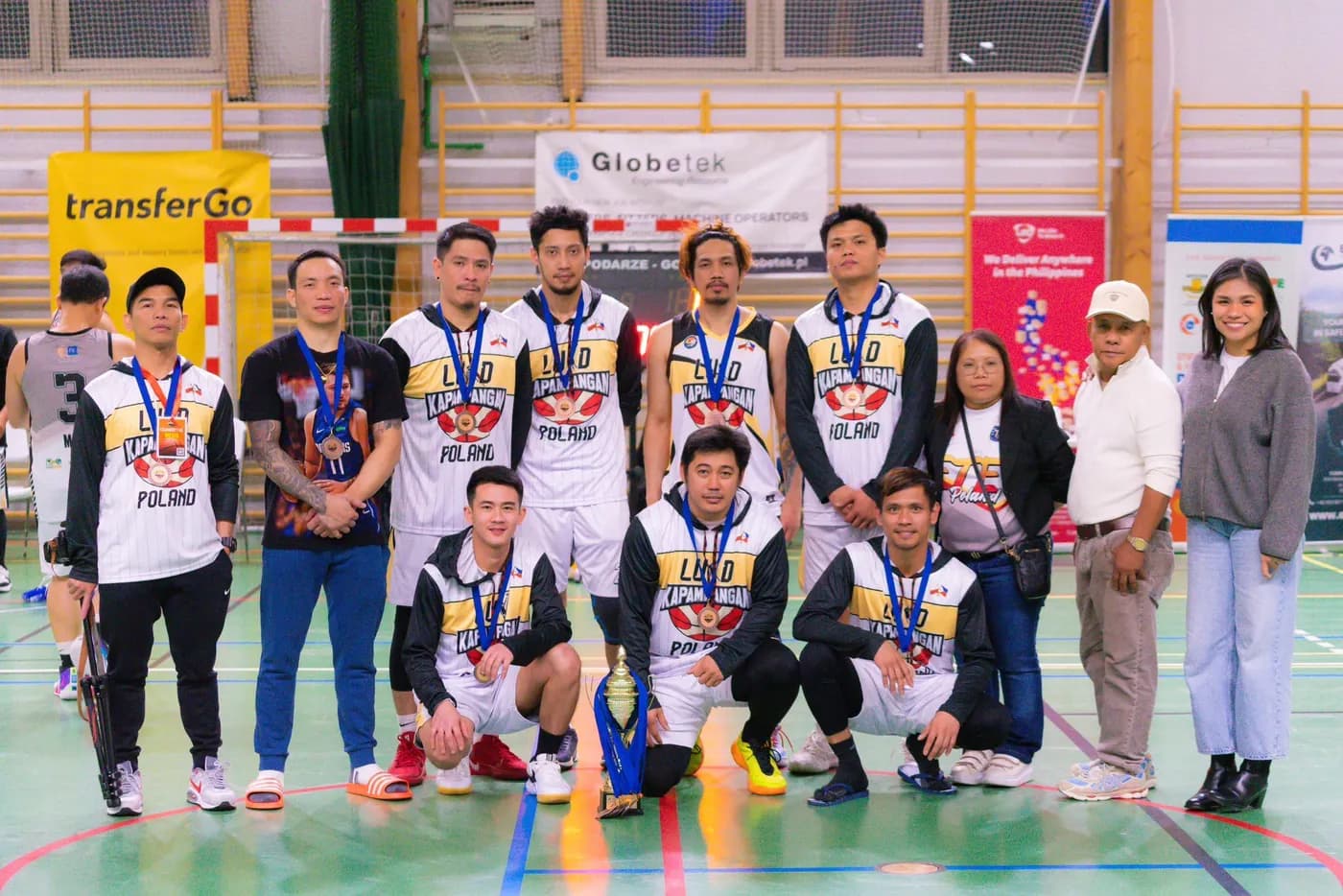 Winning team with trophy at the Filipino sports tournament in Poland