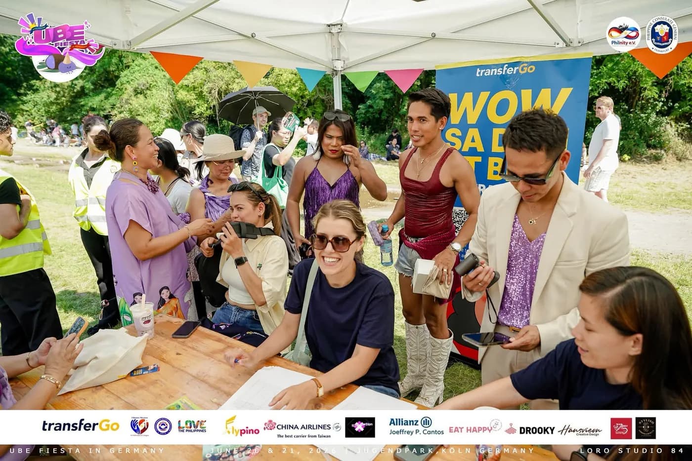 TransferGo team signing up attendees at the Ube Fiesta activation table